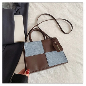 Top view of checkered brown leather and blue denim patchwork small square handbag