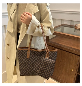 Close-up of vintage monogram tote bag with brown leather straps and detailed texture