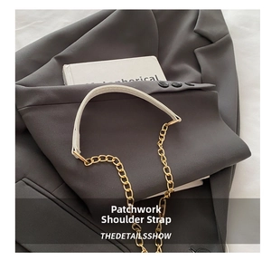 Detail of elegant two-tone faux leather and gold chain shoulder strap for handbags