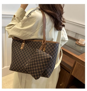 Detail view of large retro monogram tote bag and small coin pouch with leather handles