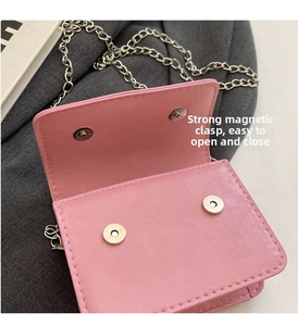 Pink bow chain bag detail showing dual magnetic snaps for easy opening and closing