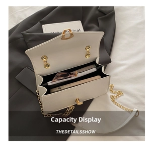Detail of off-white crocodile embossed bag showing inner storage and gold rotary lock