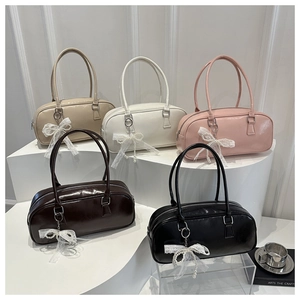 Detail showing five colors of shiny PU leather Boston bags with lace pearl charms