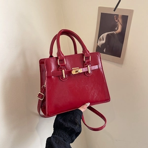 Classic red patent leather tote bag with gold metal twist lock and shoulder strap