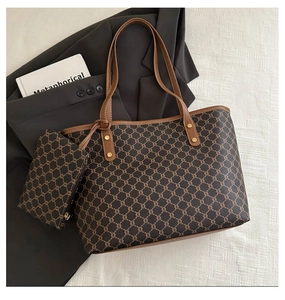 Detail of vintage brown tote set with monogram pattern and leather straps on blazer