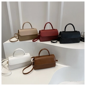 Detail of multi-color woven texture handbags with metal hardware and shoulder straps