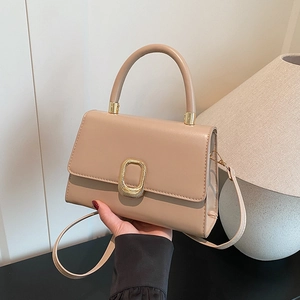 Elegant beige solid color crossbody bag with gold metal buckle and top handle for women