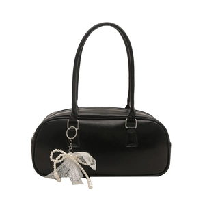 Classic black bowling bag with decorative pearl lace bow charm for versatile daily use