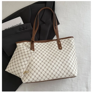 Detailed top view of vintage monogram tote bag set with matching pouch on textured fabric