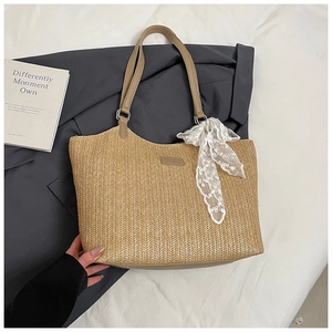 Close-up of straw woven tote with V-pattern texture and white floral lace detail