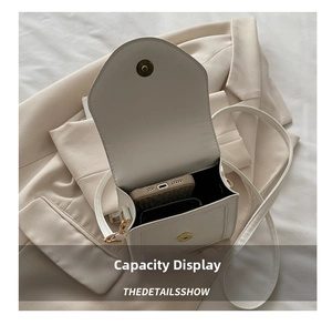 Internal view of a minimalist white crossbody bag showing mobile phone storage capacity