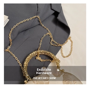 Close-up of golden woven handle and leaf texture fabric on a vintage evening bag