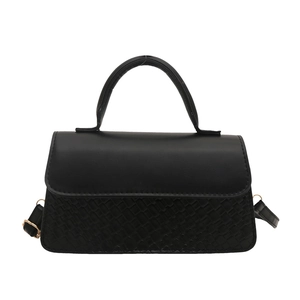 Black minimalist shoulder bag with crocodile texture and adjustable gold buckle