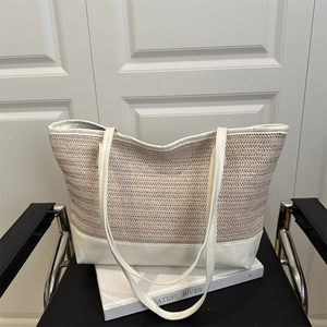 Minimalist straw weave tote bag with beige herringbone texture and white leather accents