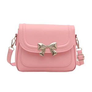 Pink crossbody square bag with gold bow ornament and adjustable leather strap on white background