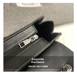 Detail showing high-quality silver metal zipper and hardware of the black quilted bag