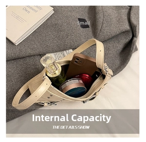 Interior view of the cream shoulder bag showing capacity for phone and cosmetics
