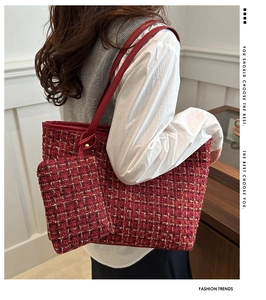 Detail of red tweed tote bag with gold thread weave and matching small pouch hanging
