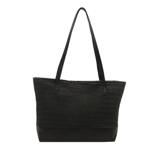 Minimalist black straw woven tote bag with smooth leather base and long shoulder straps