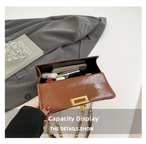 Interior view of brown leather bag showing large capacity for phone and cosmetics