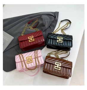 Detail of four quilted chain bags in burgundy, black, pink and brown with metal buckles