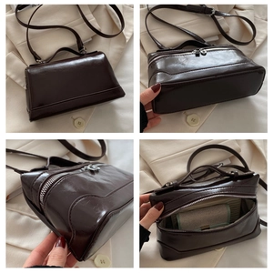 Macro view of dark brown patent leather bag with top handle and internal organizer