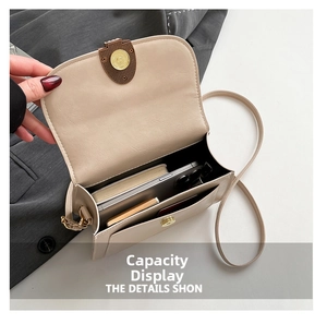 Detail view of the interior compartment and storage capacity of the beige saddle bag