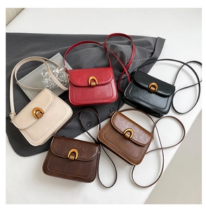 Close-up of vintage faux leather saddle bags with horseshoe buckles in five classic colors