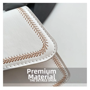 Detail of white leather bag with brown V-shaped hand-woven stitching craftsmanship