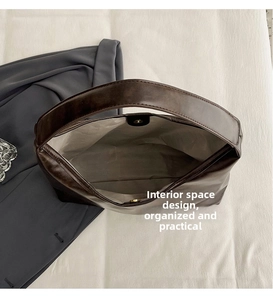 Detail view of large dark brown tote bag showing spacious interior and magnetic closure