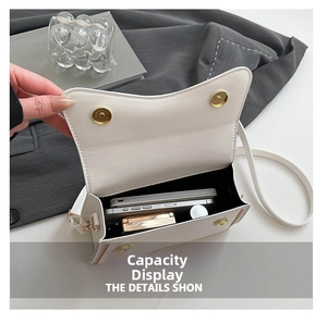 Detailed interior capacity view of white PU bag showing storage for phones and makeup