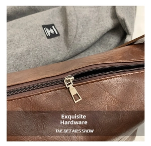 Close-up of smooth gold zipper hardware on premium brown leather tote bag detail