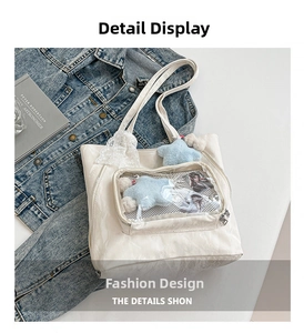 Detailed view of white tote bag with transparent window showing plush star and cards