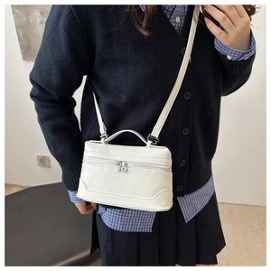 White leather mini square bag shown on model as a stylish crossbody for daily fashion