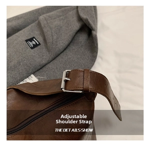 Detail of adjustable strap with silver buckle on vintage brown textured shoulder bag