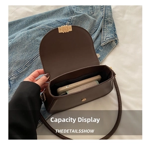 Detail view of the spacious inner compartment of this brown leather saddle shoulder bag