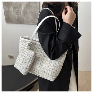 Detail of tweed tote bag set featuring premium textured weave and white leather straps