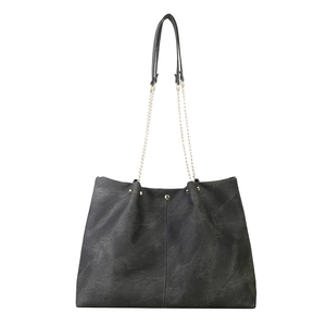 Minimalist charcoal grey tote bag with vintage texture and gold chain shoulder strap