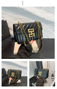 Detail of black quilted leather crossbody bag featuring a golden geometric H-lock closure