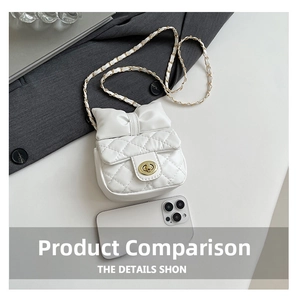 Detail of white quilted crossbody bag with bow accent and chain strap next to a phone
