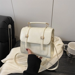 Minimalist cream white PU leather handbag with top handle and metal buckle accents