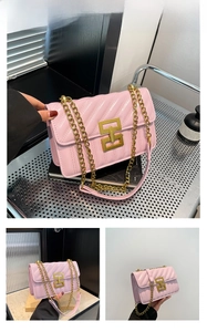 Detail of pink quilted shoulder bag with golden geometric clasp and chunky chain strap