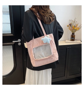 Pink ita bag detail featuring transparent mesh window and blue star plush charm