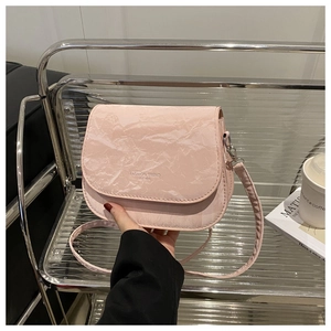 Detail of pink marble textured crossbody bag with Fashion Trend EST 1995 text engraving