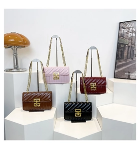Close-up of quilted chain crossbody bags in four colors with gold square buckle detail