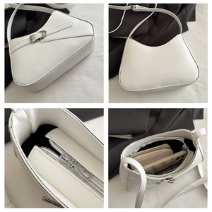 Vista detallada del bolso baguette blanco minimalista con hebilla plateada y cremallera
