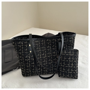 Close-up of plaid tweed tote bag set with golden studs and matching coin purse detail