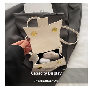 Detailed interior of minimalist off-white shoulder bag showing storage capacity
