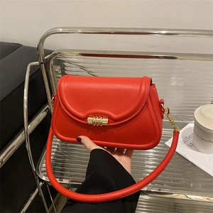Fashionable red leather shoulder bag with gold hardware lock and chain strap detail