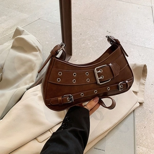 Retro punk style dark brown leather crescent shoulder bag with metallic eyelets and belt details